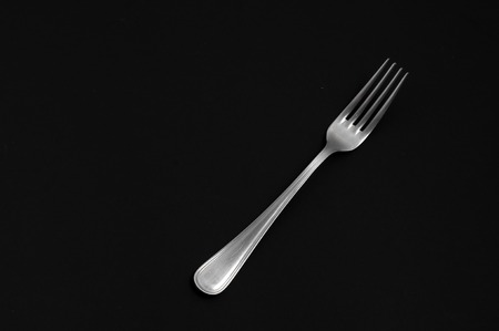 fork on a black background.の写真素材