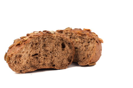 small round a bun with pumpkin seeds wherein is isolated on a white backgroundの写真素材