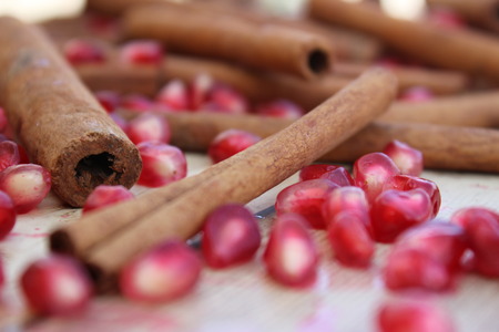 pomegranate seeds and cinnamon on a wooden surface background for Rosh Hashanaの写真素材