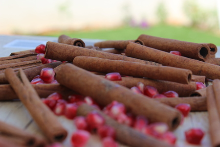 pomegranate seeds and cinnamon on a wooden surface background for Rosh Hashana