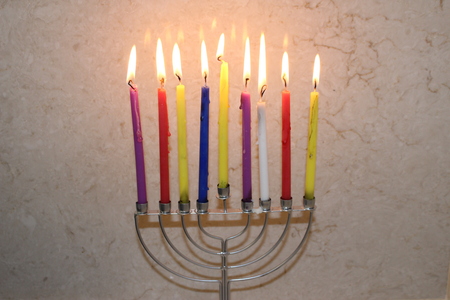 Colorful Chanukah candles lit in the menorah, Colorful Hanukkah candles are arranged in the Menorah according to the days of the holidayの写真素材