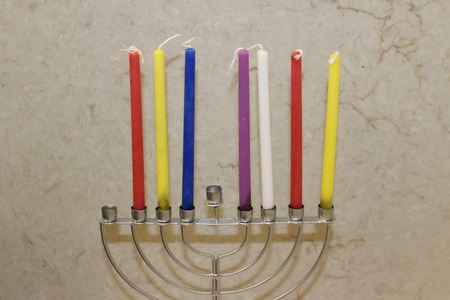 Colorful Chanukah candles lit in the menorah, Colorful Hanukkah candles are arranged in the Menorah according to the days of the holidayの写真素材