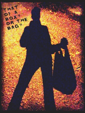 A silhouette of a man carrying a plastic bagの素材