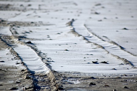 Snowy Tire Tracks on the Beachの写真素材