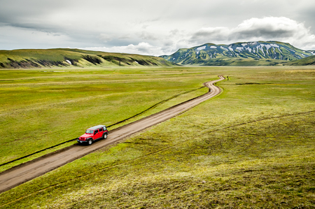 A red jeep on a track in Iceland in the Landmannalaugar regionの写真素材