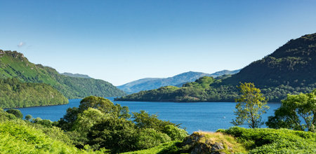 Along the West highland Way in Scotland. a wide view of the blue waters of Loch Lomond surrounded by...
