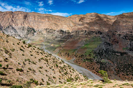 In the Atlas Mountains in Morocco. Color play between rock and vegetation in an arid valley.の写真素材