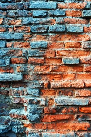 Old obsolete red brick wall covered with cyan rustの写真素材