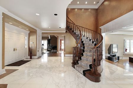 Foyer in luxury home with curved staircaseの写真素材