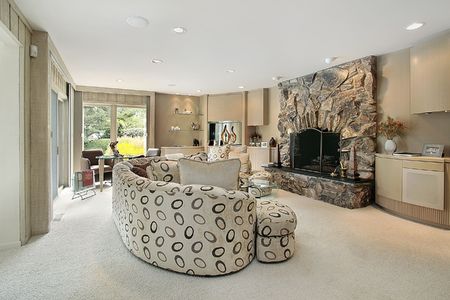 Living room in luxury home with stone fireplaceの写真素材