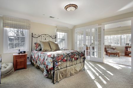 Master bedroom with sitting room and wall of windowsの写真素材