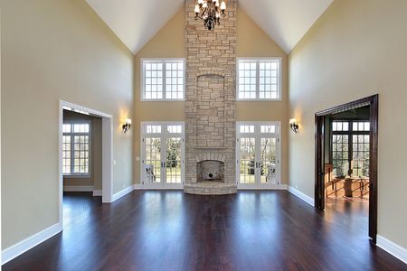 Family room in new construction home with two story stone fireplaceの写真素材
