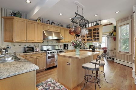 Kitchen in contemporary home with island and chairsの写真素材