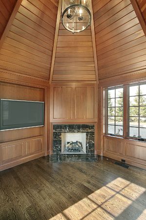 Library in new construction home with paneled walls and fireplaceの写真素材
