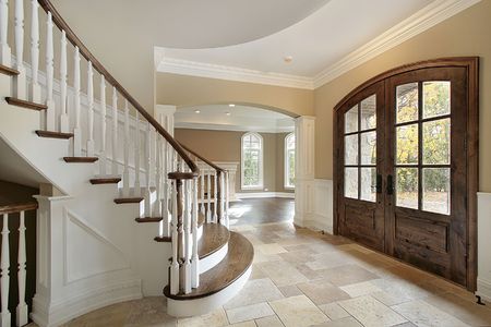 Foyer with stairway and front door in new homeの写真素材