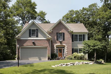 Brick home in suburbs with stone landscapingの写真素材