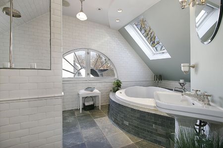 Luxury bath room with grainte floors and tubの写真素材