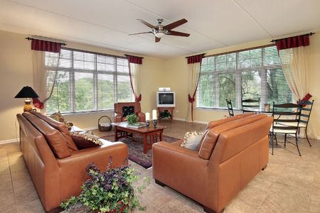 Family room in suburban home with orange sofasの写真素材