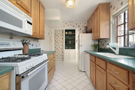 Kitchen with green counters and wood cabinetryの写真素材