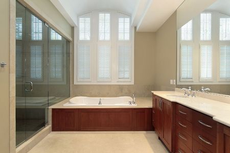 Master bath in new construction home with wood paneled tubの写真素材