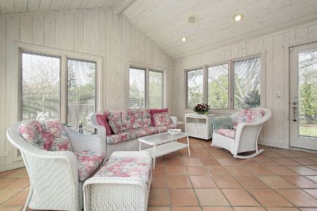 Porch in suburban home with white wicker furnitureの写真素材