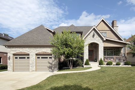 Luxury stone home with arched entry and front porchの写真素材