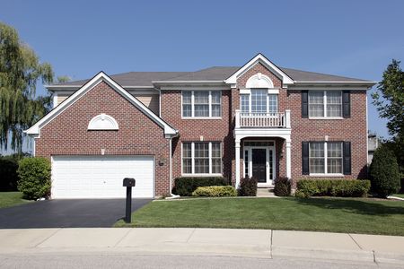Luxury brick home in suburbs with front balconyの写真素材