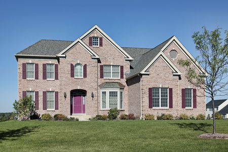 Brick home in suburbs with pink doorの写真素材