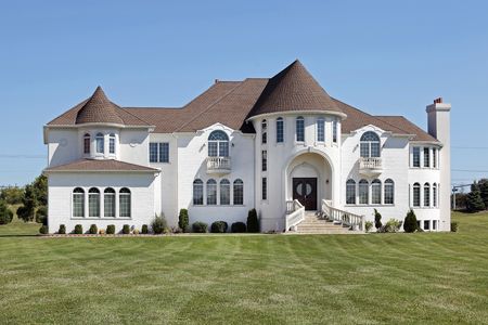 Large luxury white home with front turretの写真素材