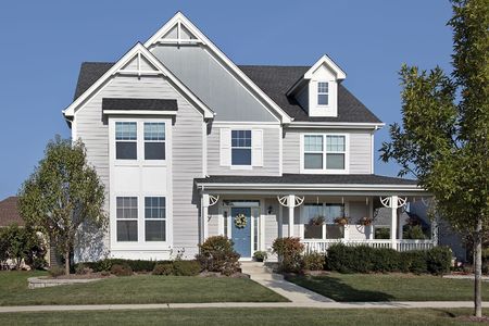 Suburban home with front porch and blue doorの写真素材