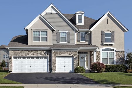 Home in suburbs with three car stone garageの写真素材