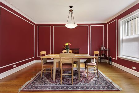 Dining room in condo with red wallsの写真素材