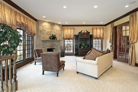 Family room in luxury home with stone fireplaceの写真素材