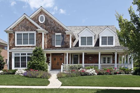 Suburban home with flowered landscaping and front porchの写真素材