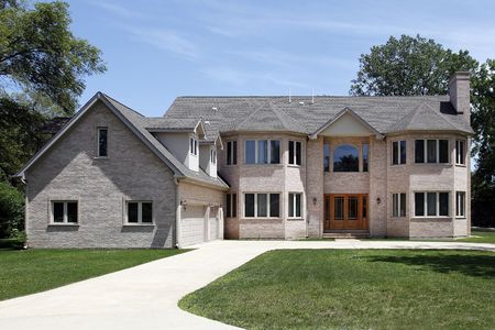 Large brick home in suburbs with three car garageの写真素材
