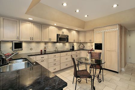 Kitchen in townhouse with light oak cabinetryの写真素材