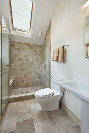 Loft bathroom with stone shower and skylightの写真素材