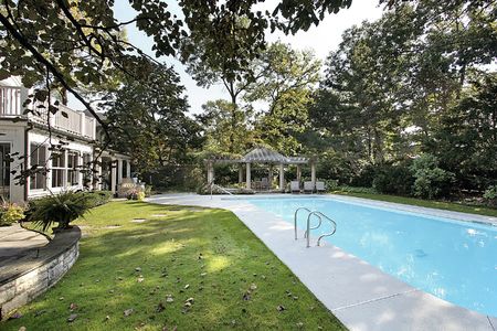 Swimming pool in back of luxury homeの写真素材