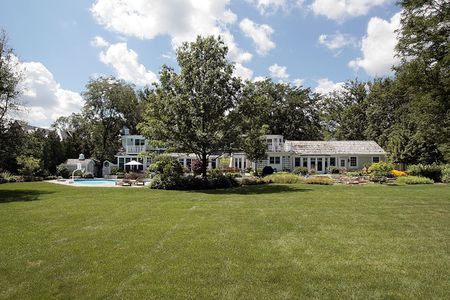 Rear view of large home with swimming poolの写真素材