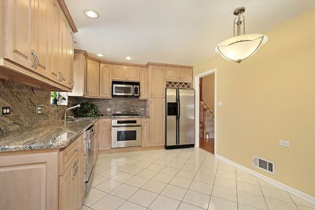 Kitchen in suburban home with oak wood cabinetryの写真素材