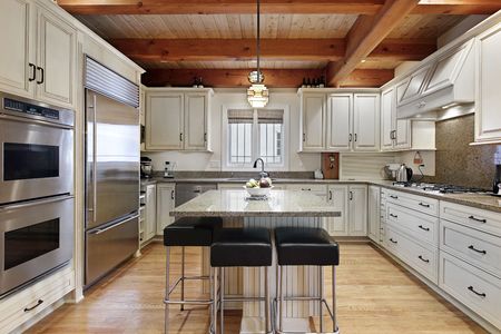 Kitchen in luxury home with wood ceiling beamsの写真素材