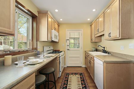 Kitchen in suburban home with oak wood cabinetryの写真素材