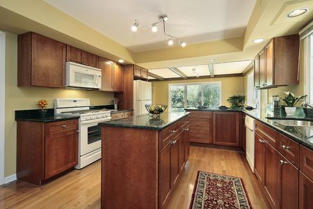 Kitchen in remodeled home with black granite countersの写真素材