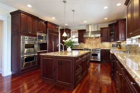 Kitchen in luxury home with cherry wood cabinetryの写真素材