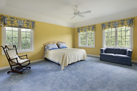 Large bedroom in home with yellow wallsの写真素材