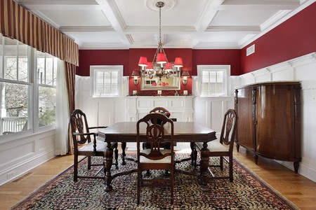 Dining room in luxury home with red wallsの写真素材