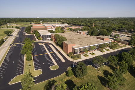 Aerial view of a high school with parking lot and ballfields in a suburban setting in Northbrook, ILの写真素材