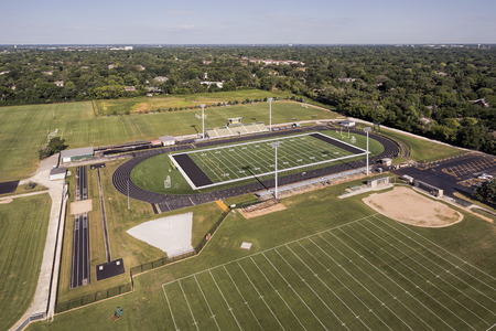 Aerial view of a high school football field and track in a suburban setting in Northbrook, ILのeditorial素材