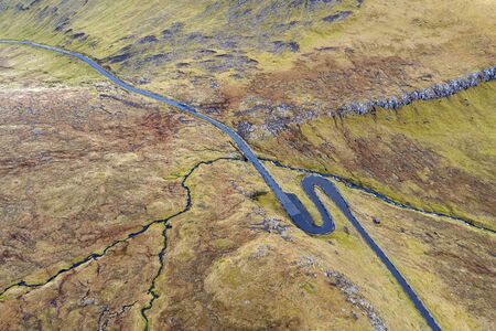 Aerial view of a winding road in the mountains near the village of Funningur in the Faroe Islands.の写真素材