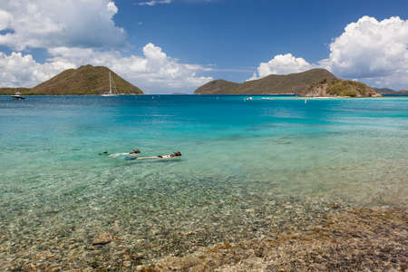 Snorkelers in Leinster Bay with boats in harbor on the island of St. John in the United States Virgin Islands.の写真素材